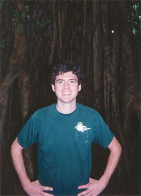 Photo of John in front of a strangler fig by Justin Hunter Dec 1996.