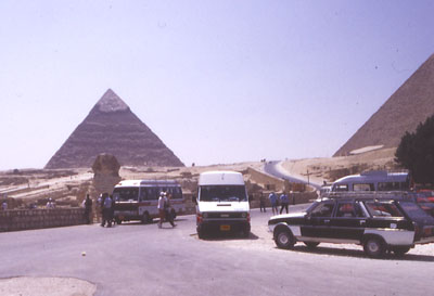 photo of pyramids with traffic in foreground